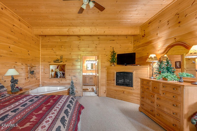 1304 Timberwolf Way Sevierville, TN 37876 - Photo 28 of 36 a living room with furniture flat screen tv and a fireplace