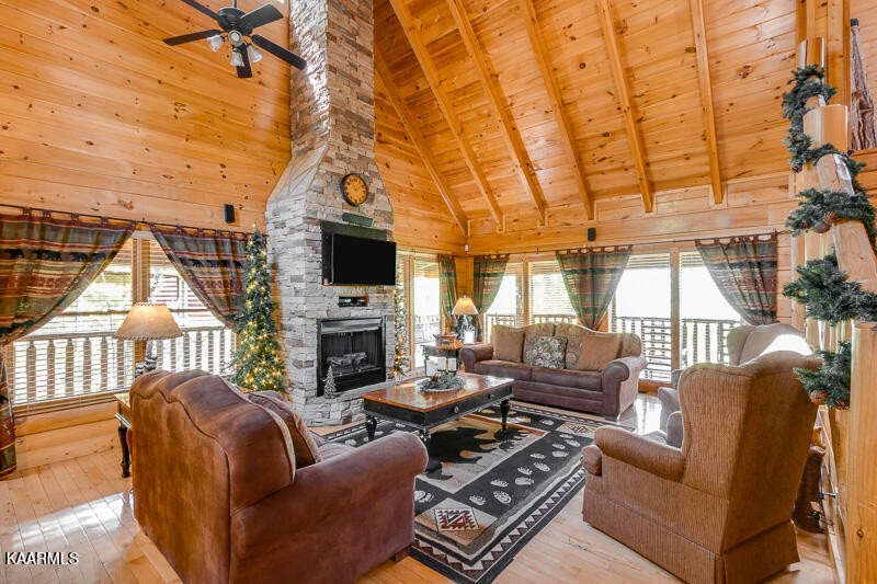 1304 Timberwolf Way Sevierville, TN 37876 - Photo 6 of 36 a living room with furniture a fireplace and a flat screen tv