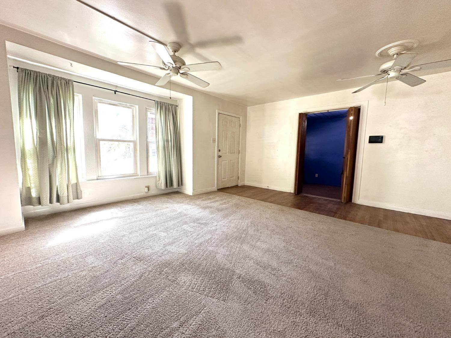 3004 43rd Street Lubbock, TX 79413 - Photo 2 of 8 an empty room with windows and closet