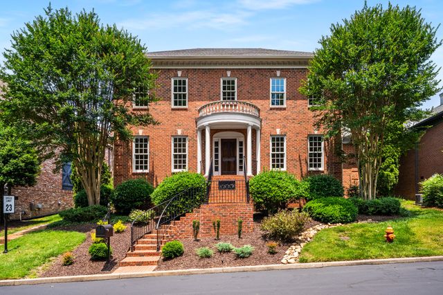a front view of a house with a yard garage and outdoor seating