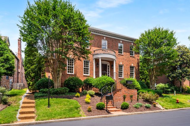 a living room with furniture a window and wooden floor