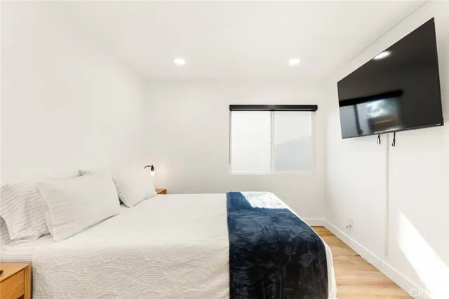 a bedroom with a bed and a flat screen tv