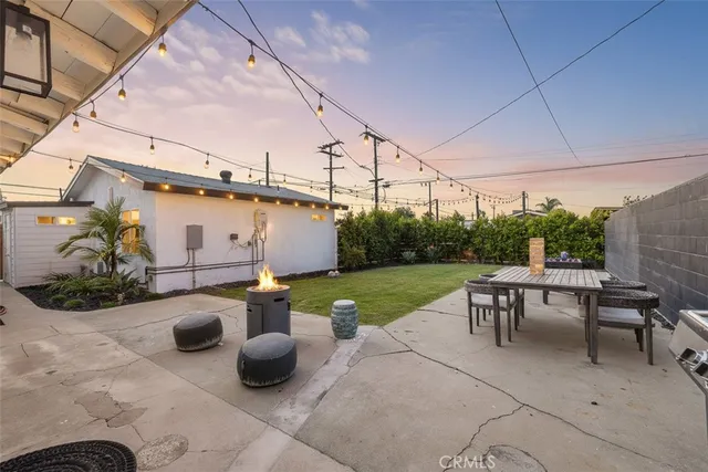 a view of a patio with chairs and plants