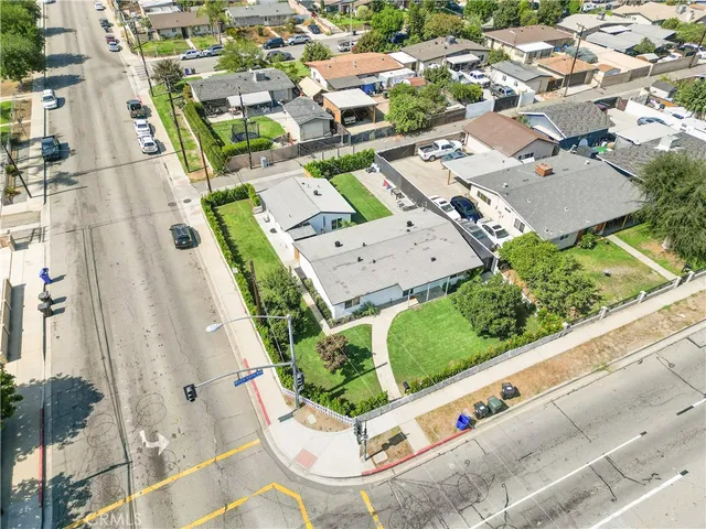 an aerial view of a residential houses with yard