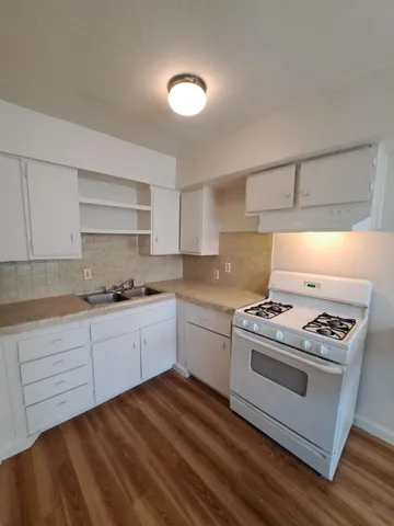 a kitchen with a stove oven and sink