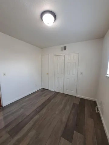 a view of an empty room and wooden floor