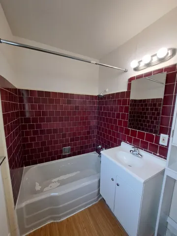 a bathroom with a bathtub and shower