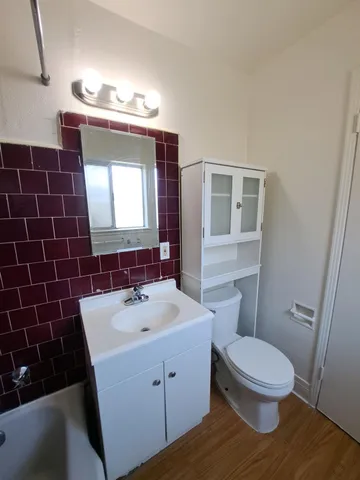 a bathroom with a sink a toilet and mirror