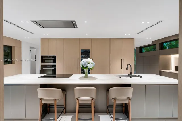 a kitchen with stainless steel appliances a sink and a refrigerator