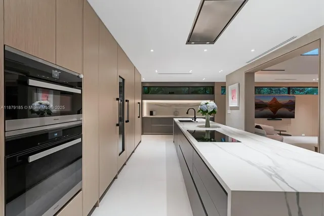 a kitchen with stainless steel appliances a sink and cabinets