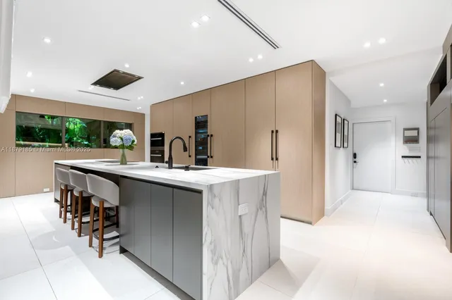 a view of a backyard with plants and large trees