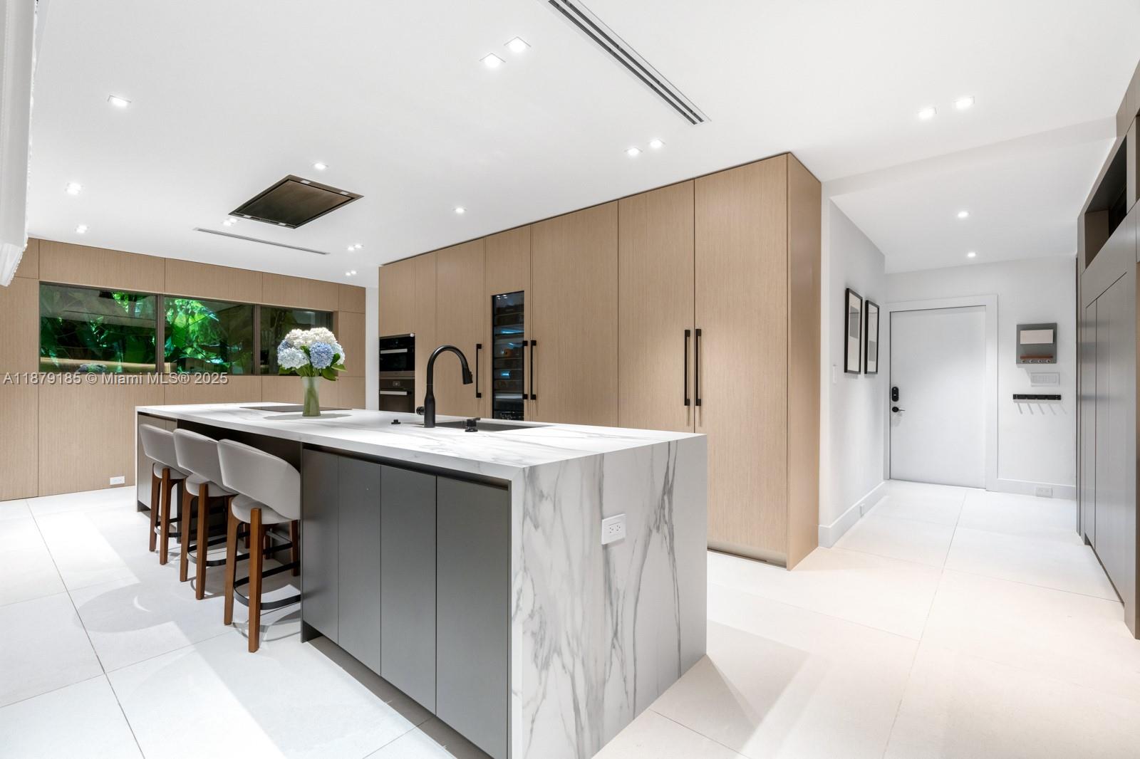 3651 St Gaudens Road Coconut Grove, FL 33133 - Photo 13 of 70 a kitchen with stainless steel appliances a sink and a refrigerator