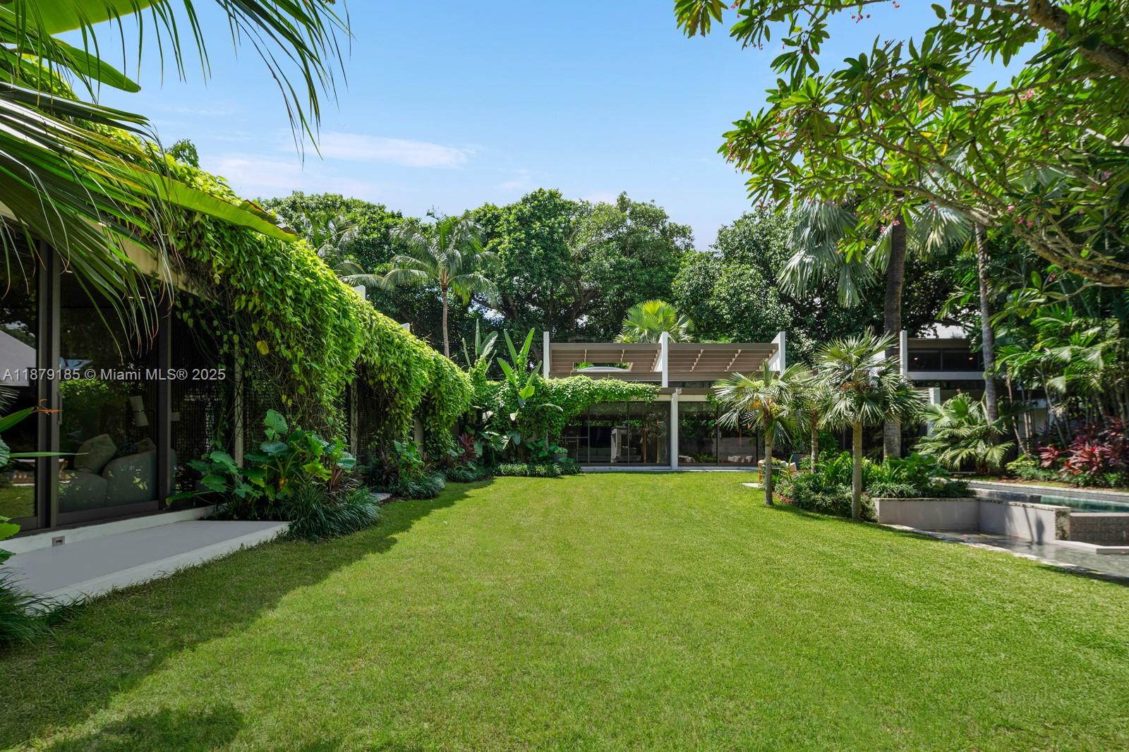 3651 St Gaudens Road Coconut Grove, FL 33133 - Photo 15 of 70 a view of a backyard with plants and large trees