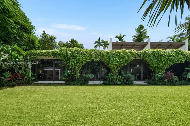 a bedroom with a large bed and a large window