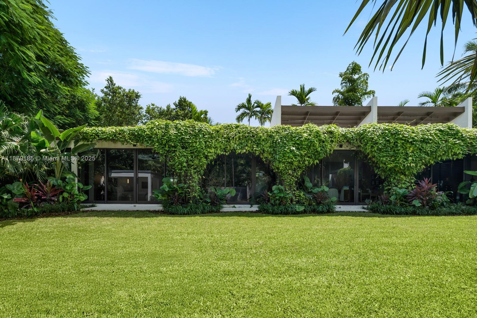 3651 St Gaudens Road Coconut Grove, FL 33133 - Photo 17 of 70 a front view of a house with garden