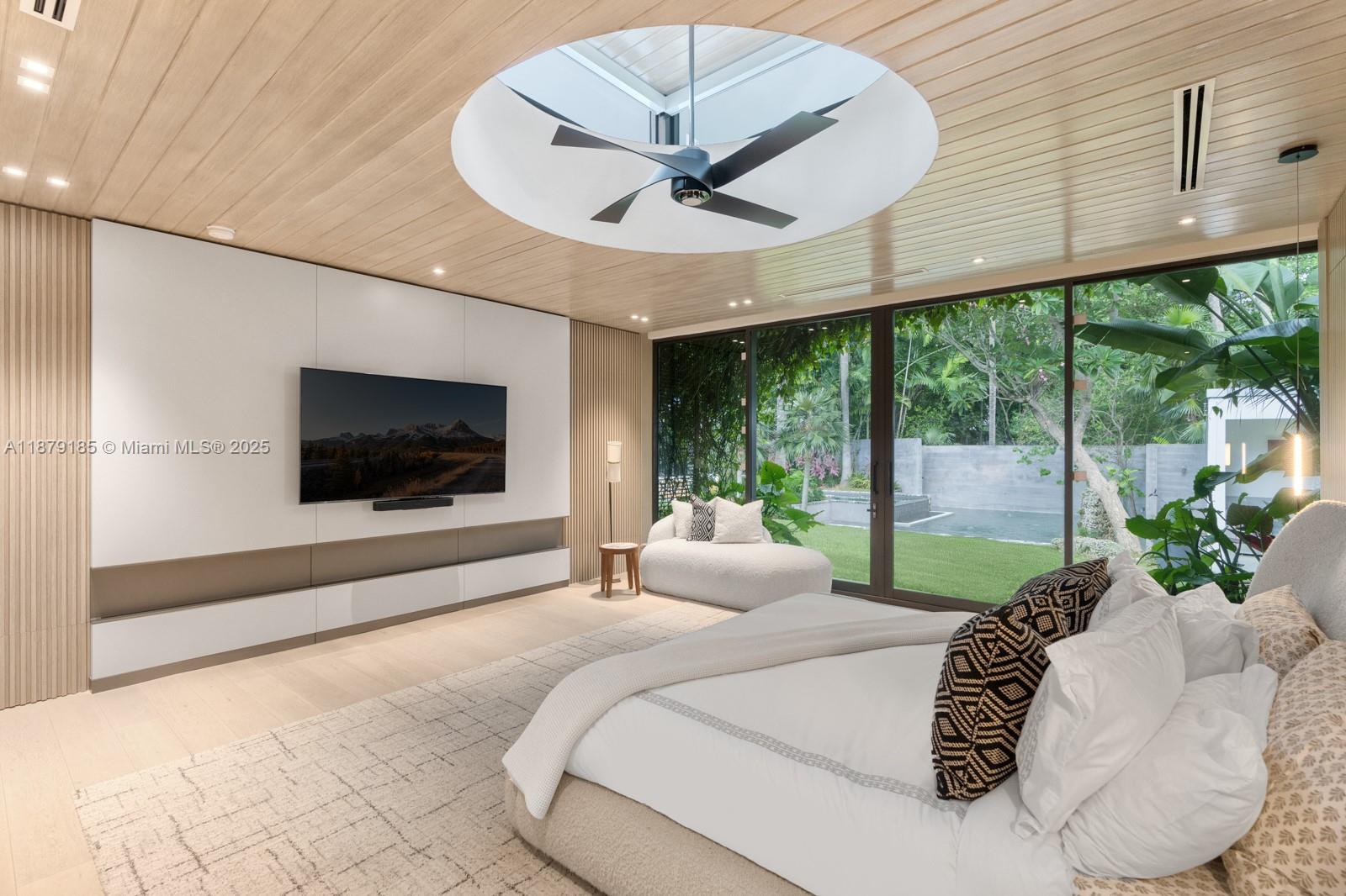 3651 St Gaudens Road Coconut Grove, FL 33133 - Photo 26 of 70 a bedroom with a large bed and a flat tv screen on dresser