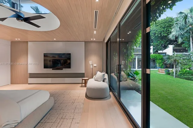 a living room with furniture and large windows