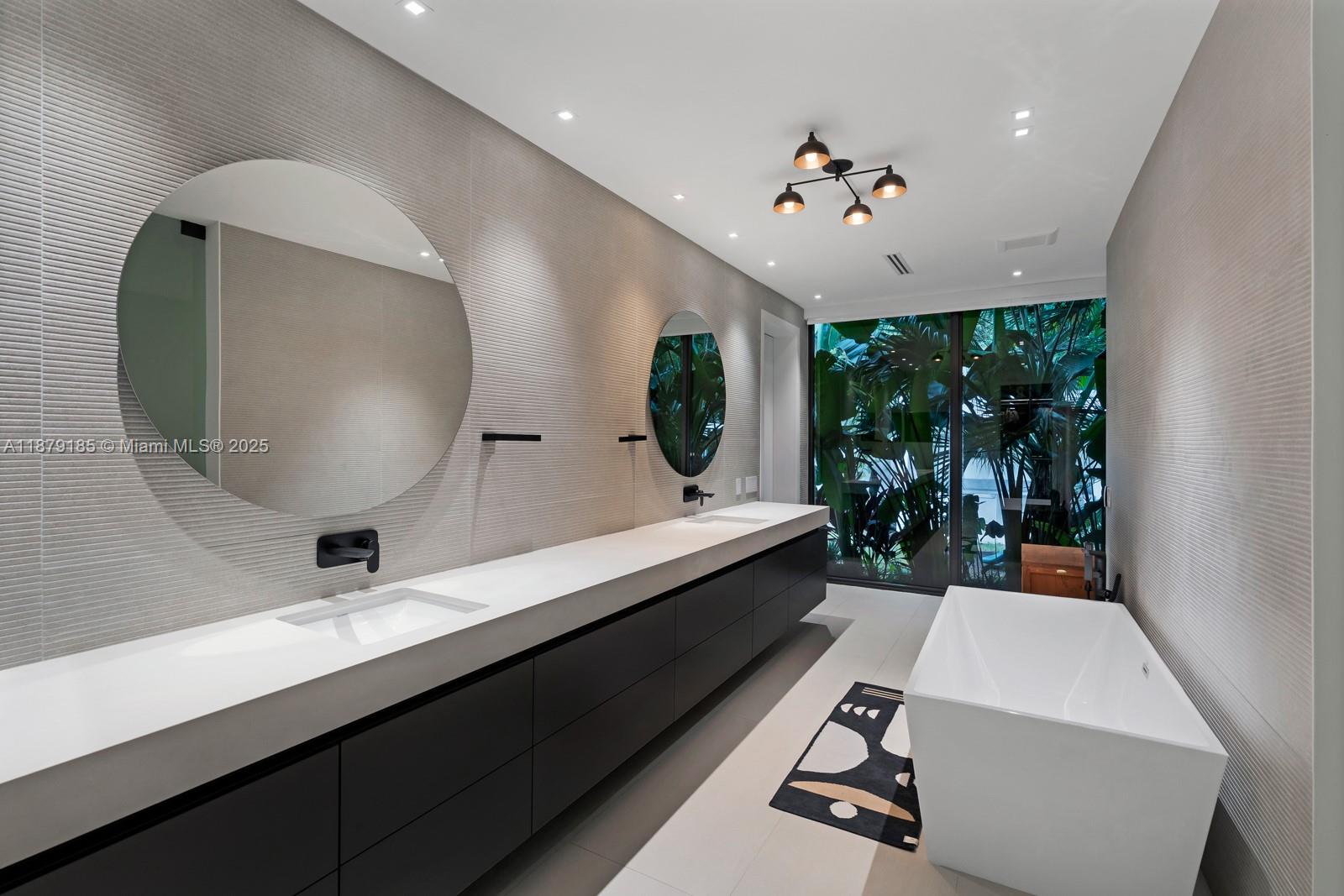 3651 St Gaudens Road Coconut Grove, FL 33133 - Photo 28 of 70 a very nice looking room with a large window and chandelier