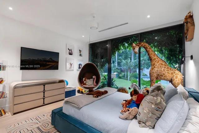 a living room with a bed and a large window