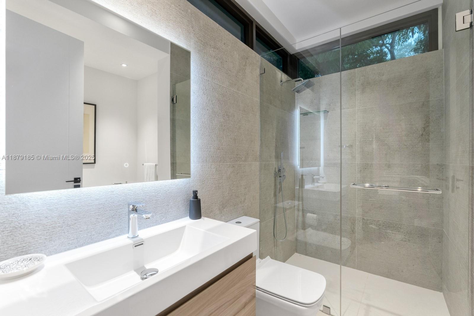 3651 St Gaudens Road Coconut Grove, FL 33133 - Photo 40 of 70 a bathroom with a sink toilet a mirror and shower