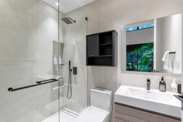 an aerial view of residential house with outdoor space and trees all around