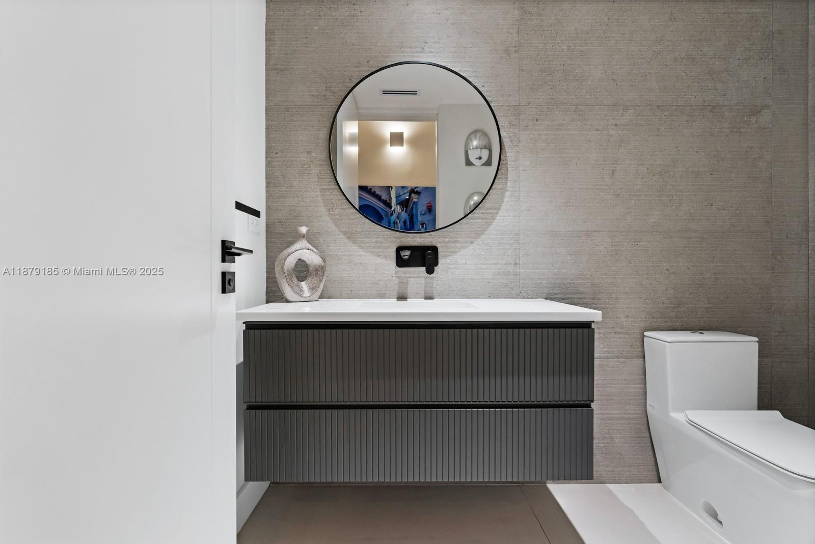 3651 St Gaudens Road Coconut Grove, FL 33133 - Photo 47 of 70 a bathroom with a sink and a mirror