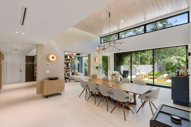 a dining room with furniture water view and a large window