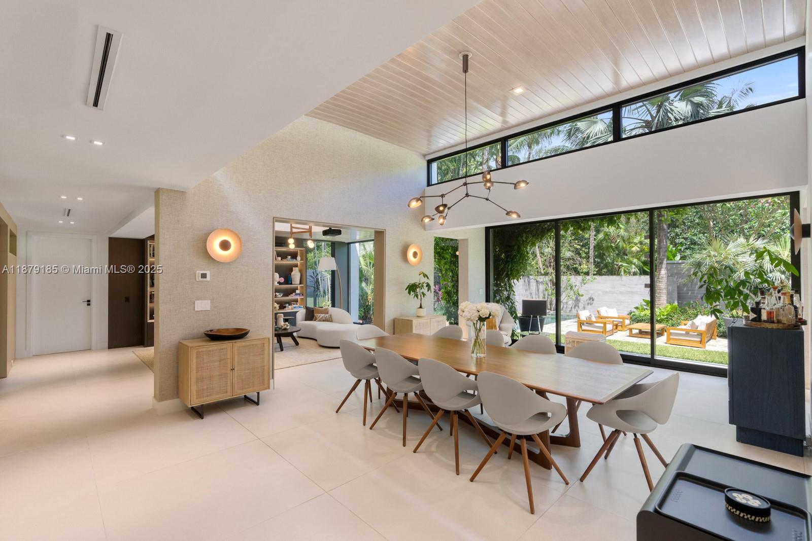 3651 St Gaudens Road Coconut Grove, FL 33133 - Photo 7 of 70 a dining room with furniture water view and a large window