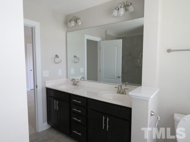 1517 Catch Fly Lane Durham, NC 27713 - Photo 28 of 44 a bathroom with a double vanity sink and a mirror