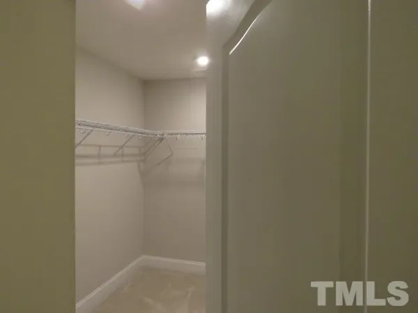 a spacious bathroom with a granite countertop sink and a bathtub