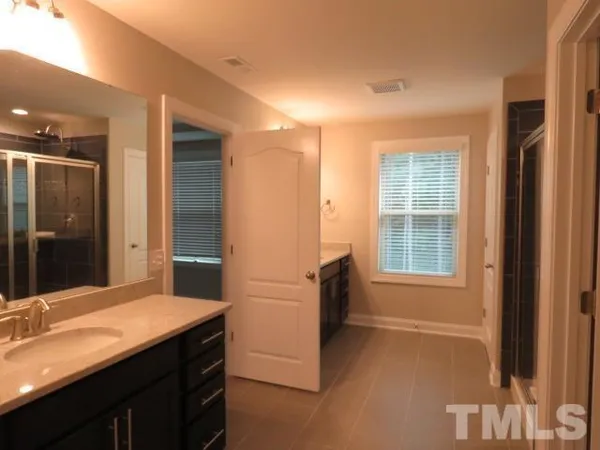 a bathroom with a shower and a sink
