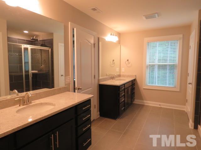 1517 Catch Fly Lane Durham, NC 27713 - Photo 39 of 44 a spacious bathroom with a granite countertop sink and a bathtub
