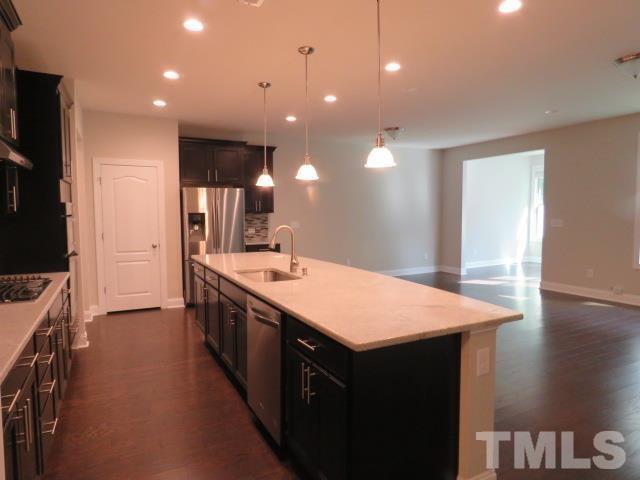 1517 Catch Fly Lane Durham, NC 27713 - Photo 6 of 44 a large kitchen with a counter space a sink and stainless steel appliances