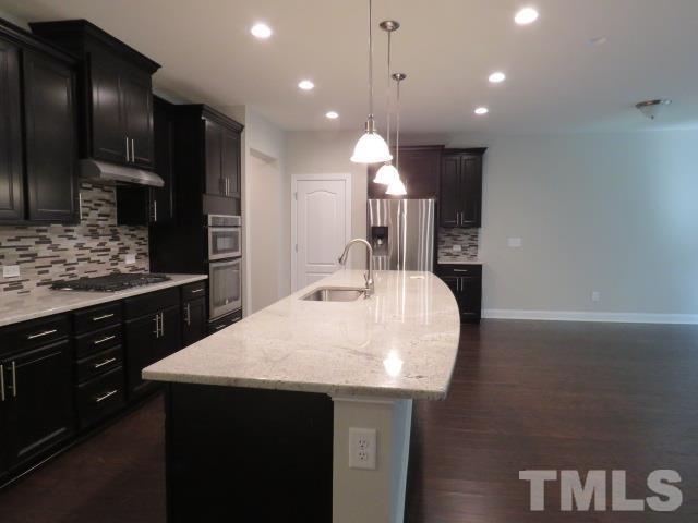 1517 Catch Fly Lane Durham, NC 27713 - Photo 7 of 44 a kitchen with a sink a counter space appliances and cabinets