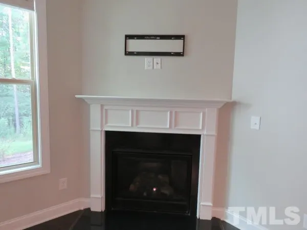 a room with a fireplace and a window