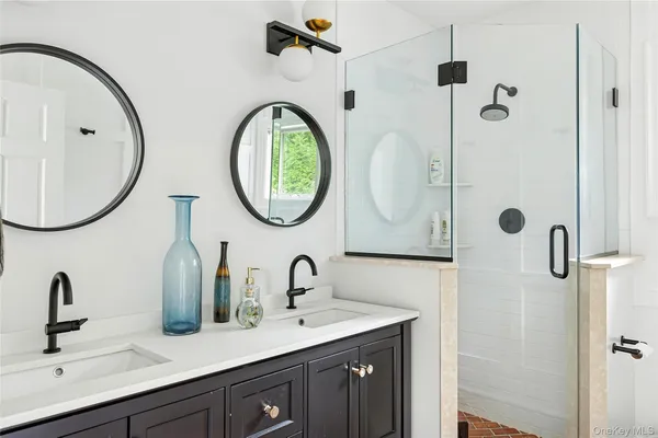 a bedroom with a bed a desk and chair with a large mirror