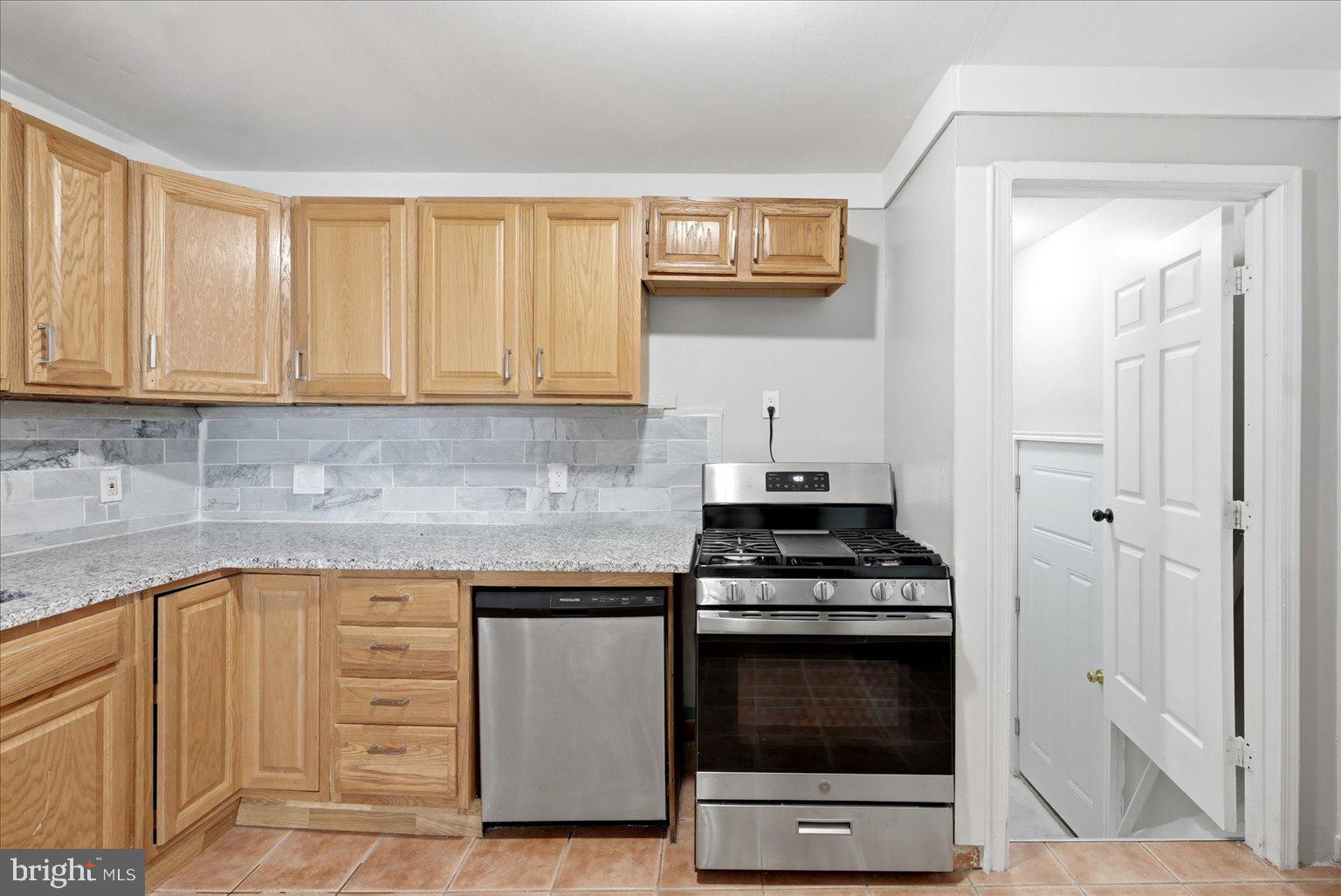 9110 Meadow Heights Road Randallstown, MD 21133 - Photo 15 of 39 Modern kitchen with warm wood accents.