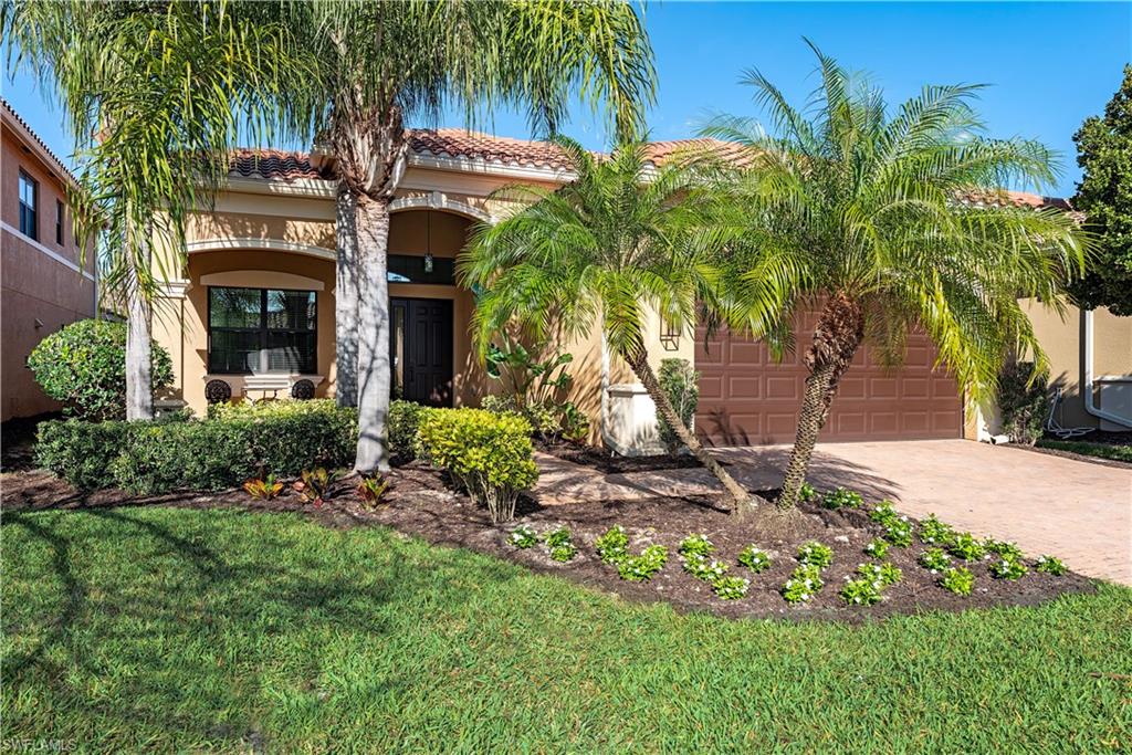 3487 Pacific Drive Naples, FL 34119 - Photo 1 of 33 a front view of a house with garden