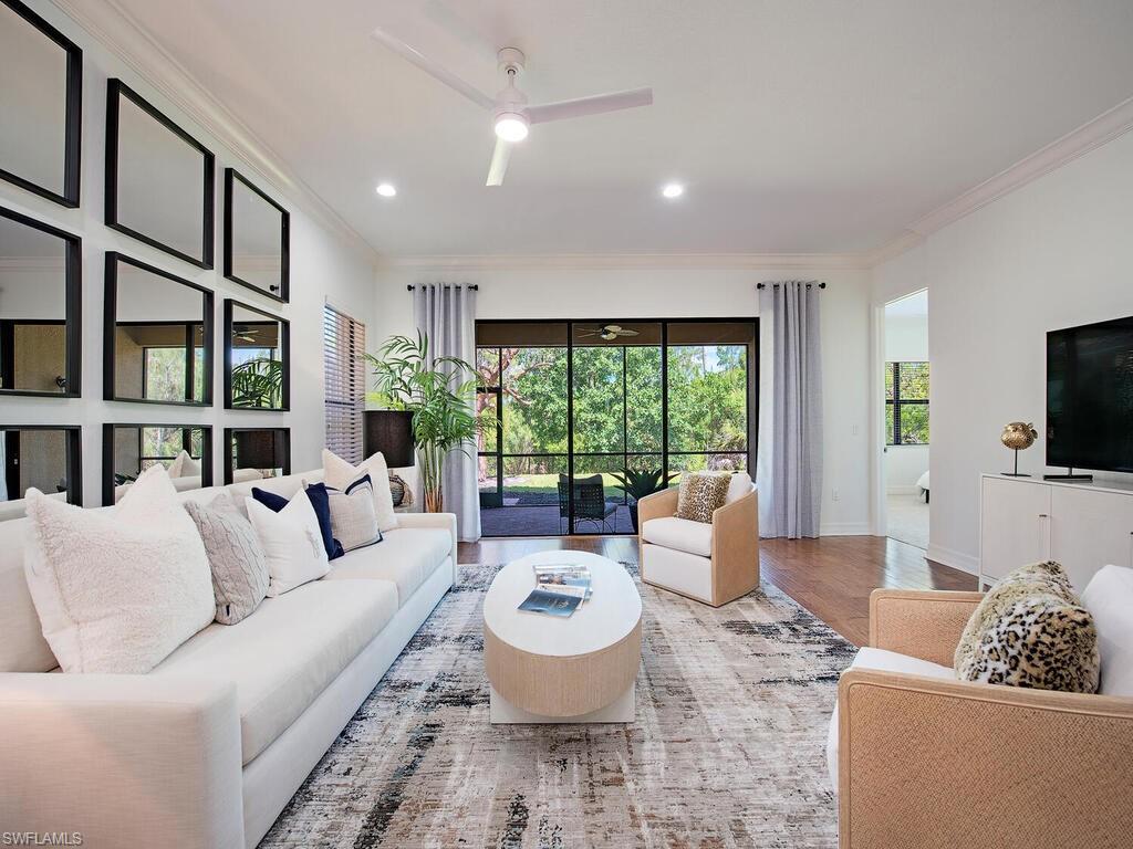 3487 Pacific Drive Naples, FL 34119 - Photo 2 of 33 a living room with furniture and a flat screen tv