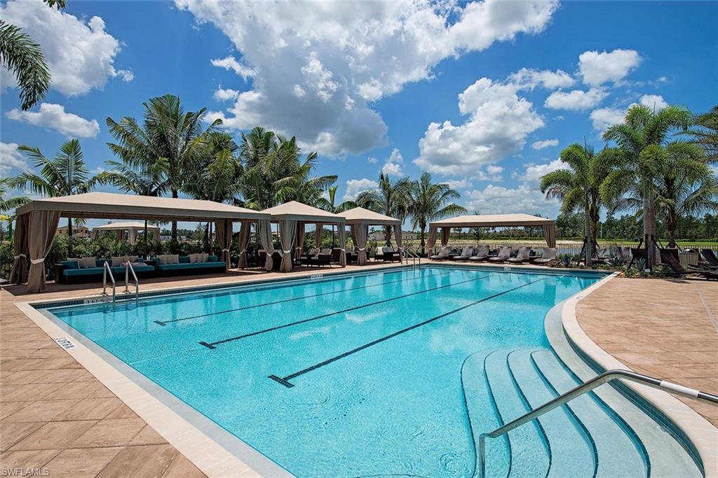3487 Pacific Drive Naples, FL 34119 - Photo 27 of 33 swimming pool view with sitting space and garden view