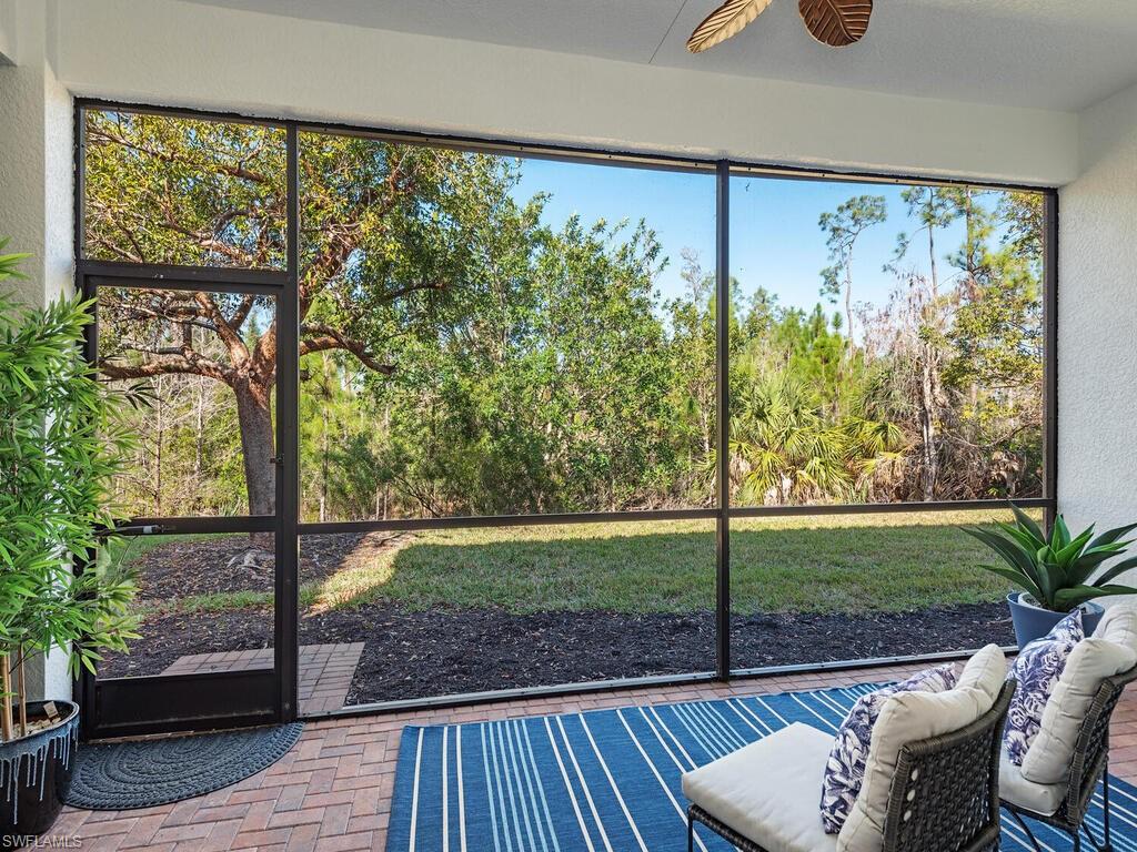 3487 Pacific Drive Naples, FL 34119 - Photo 3 of 33 a view of a porch with furniture and garden