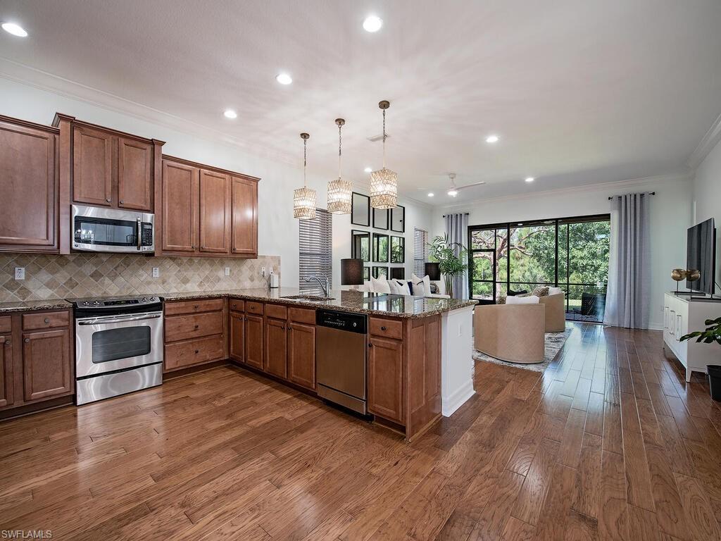 3487 Pacific Drive Naples, FL 34119 - Photo 5 of 33 a large kitchen with stainless steel appliances lots of counter top space