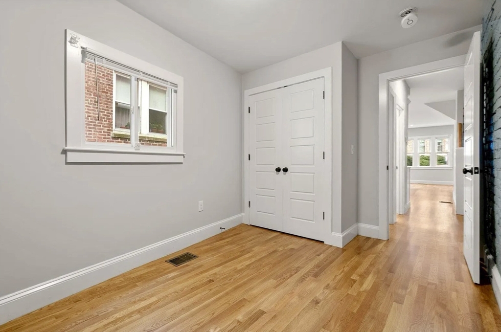 129 Sutherland Road Boston, MA 02135 - Photo 3 of 12 a view of a room with wooden floor and a window