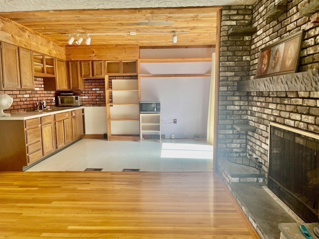 128 North Street Rochester, MA 02770 - Photo 15 of 32 a kitchen with stainless steel appliances wooden floor and a refrigerator