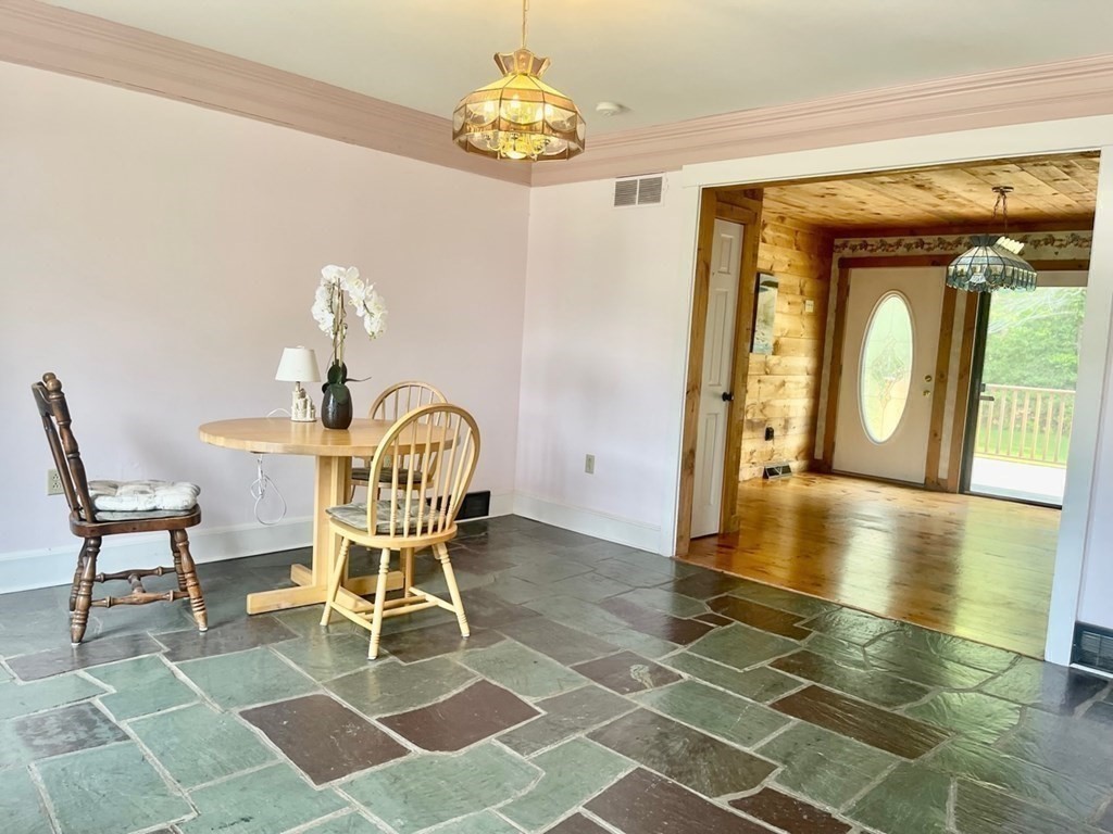 128 North Street Rochester, MA 02770 - Photo 16 of 32 a view of a dining room with furniture wooden floor and a chandelier