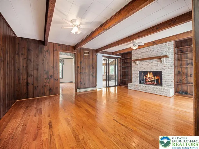 a living room with a fireplace and a floor to ceiling window