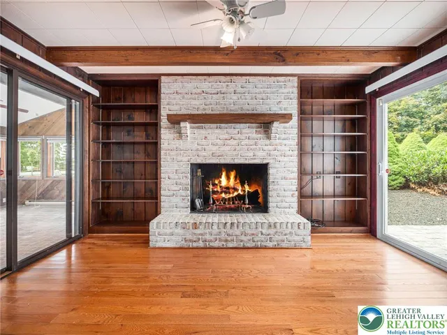 a view of a livingroom with a ceiling fan and a large window