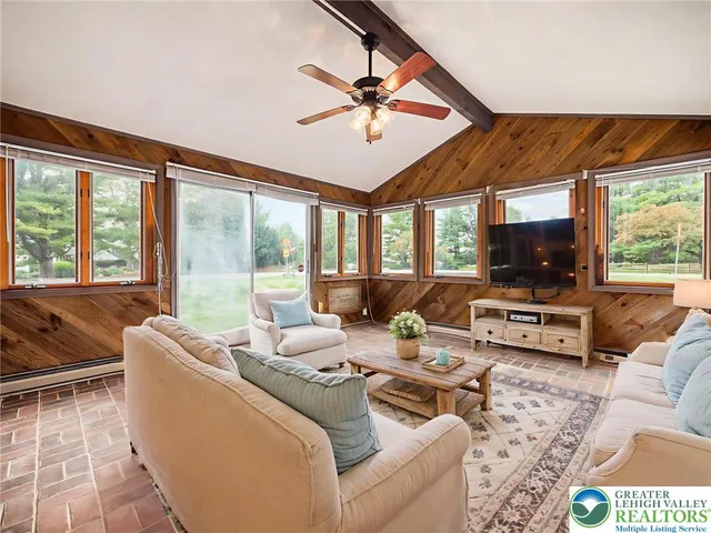 a view of a livingroom with a floor to ceiling window and a yard