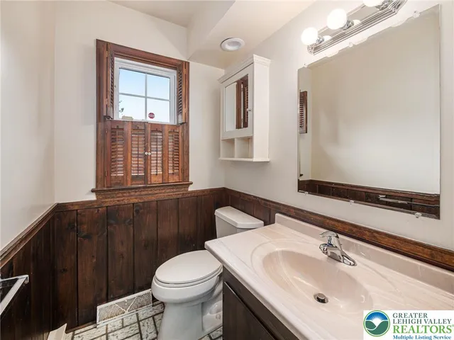 a large kitchen with stainless steel appliances granite countertop a sink and cabinets