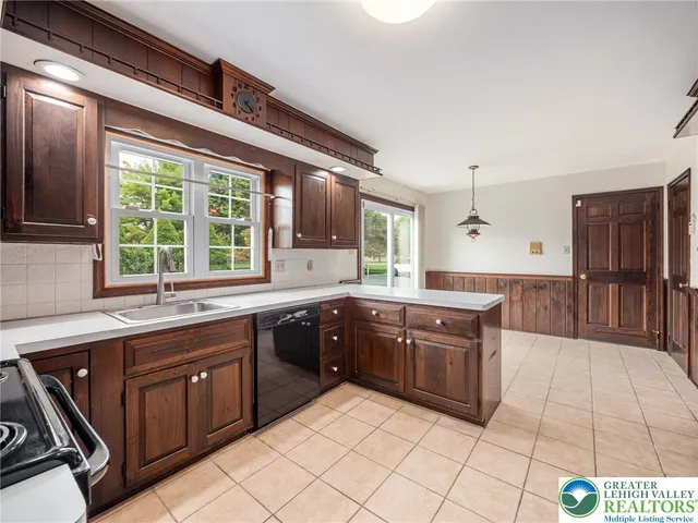 a kitchen with stainless steel appliances granite countertop a refrigerator and a stove